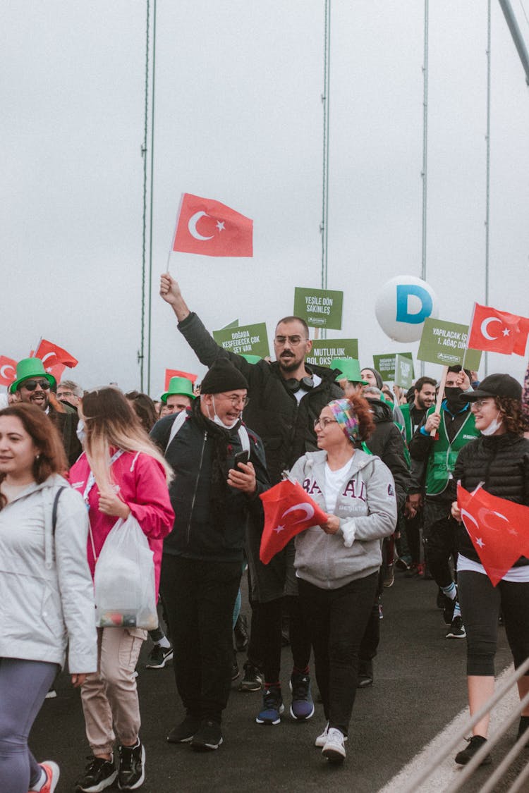 People Holding Turkish Flag Walking On The Street