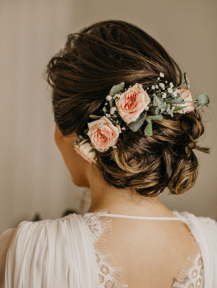 Woman in a wedding updo with flowers in her hair