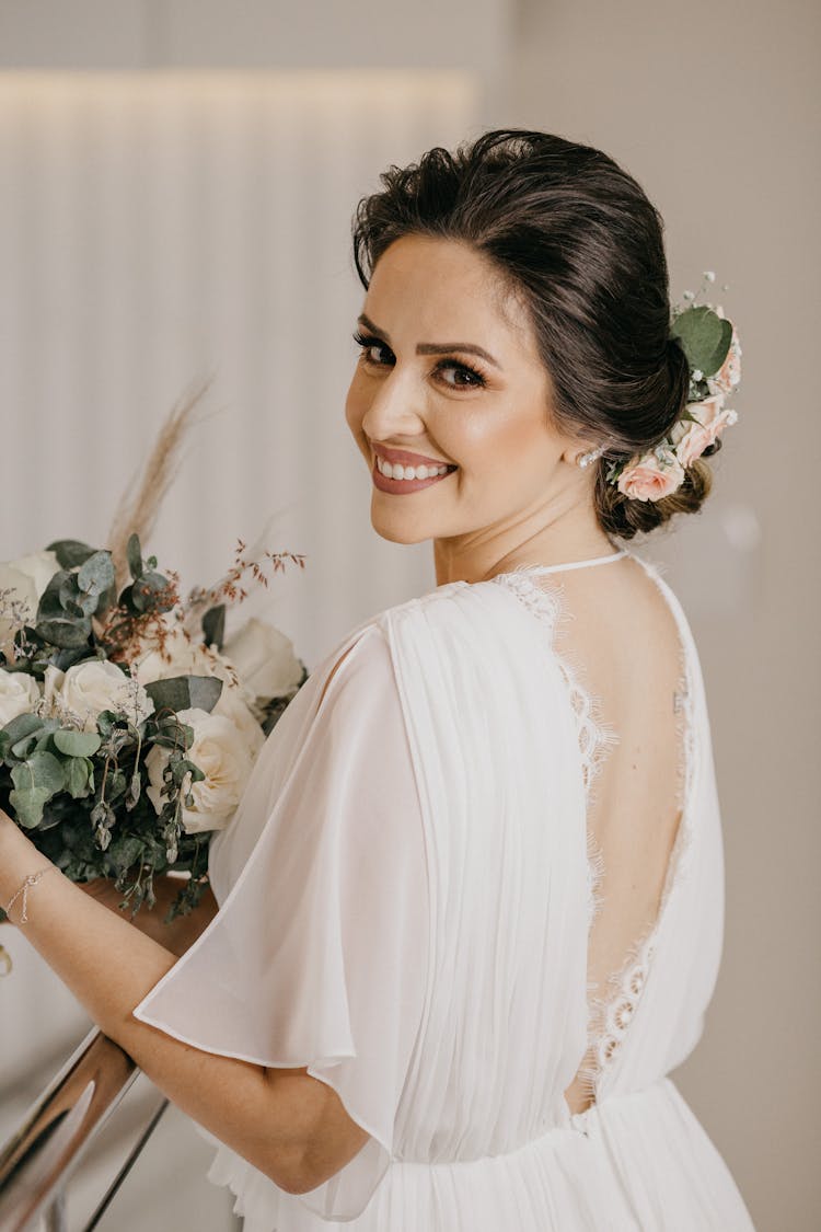 Bride In White Dress And Updo Holding Bouquet