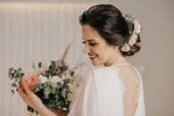 Bride in White Dress and Updo Holding Bouquet
