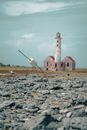 White and Brown Concrete Lighthouse Under Blue Sky
