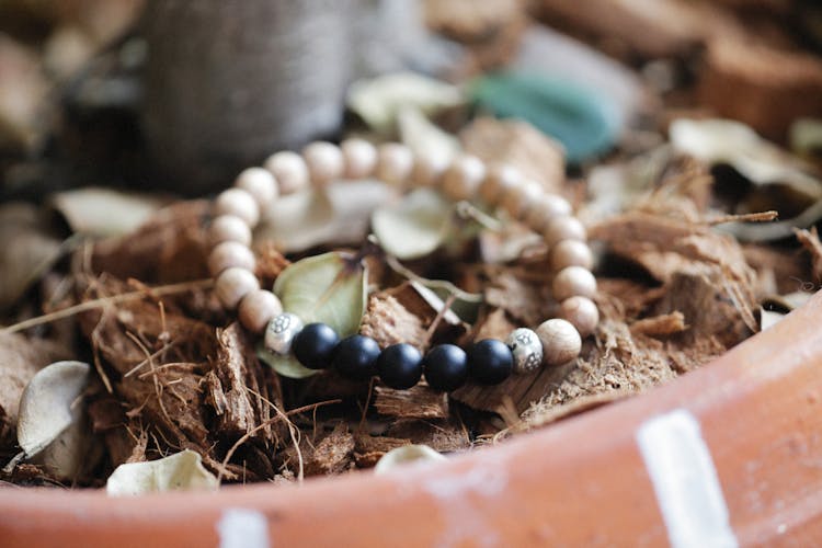 Bracelet On Soil In Flowerpot