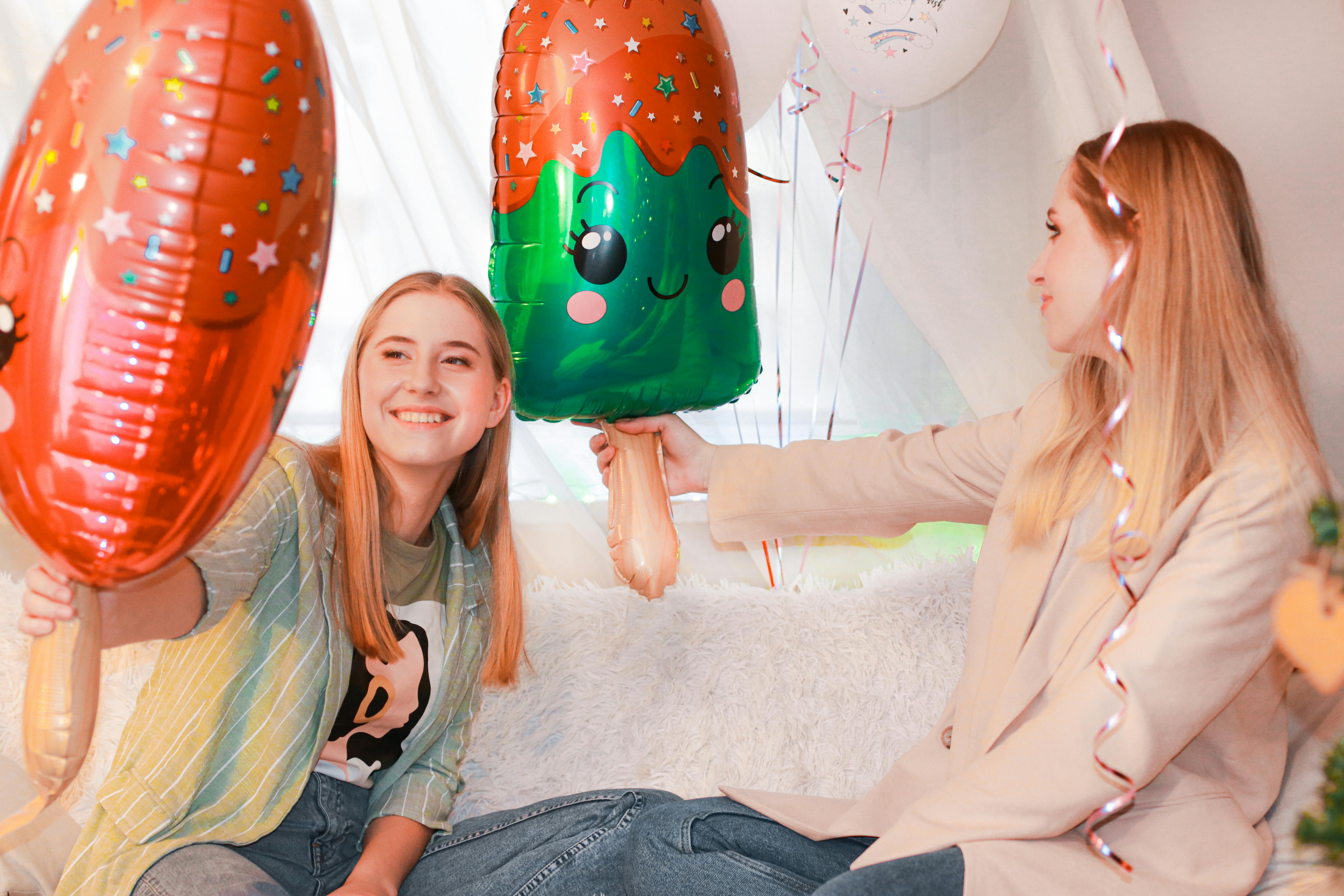 Photo of Smiling Woman Holding Bundle of Orange Balloons · Free Stock Photo