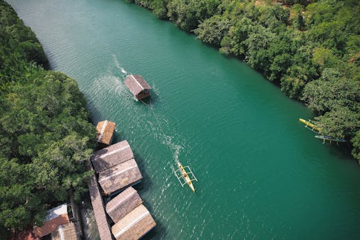 Stunning aerial shot of a serene river with traditional boats in Bolinao, Ilocos Region, Philippines.