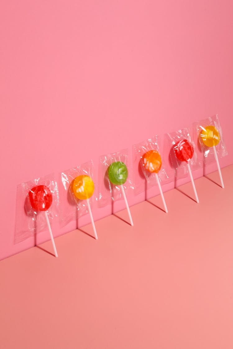 Colorful Lollipops Lined Up Against Wall