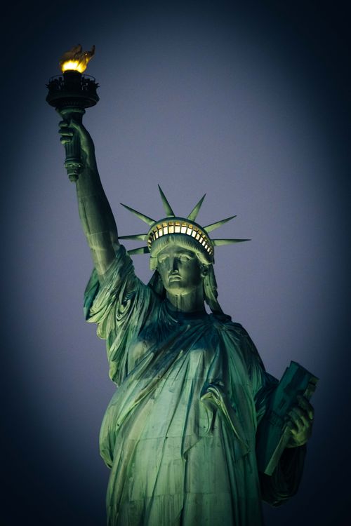 Free Close-up of the Statue of Liberty illuminated against a night sky in New York City. Stock Photo