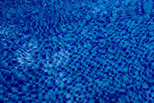 High-quality photo of shimmering blue water with a checkered tile pattern accentuated by ripples.