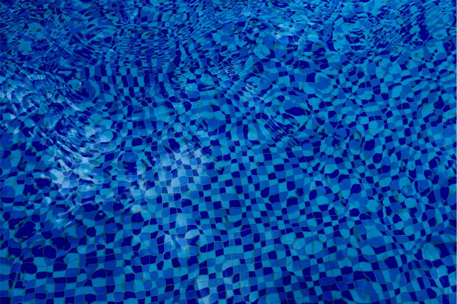 High-quality photo of shimmering blue water with a checkered tile pattern accentuated by ripples.