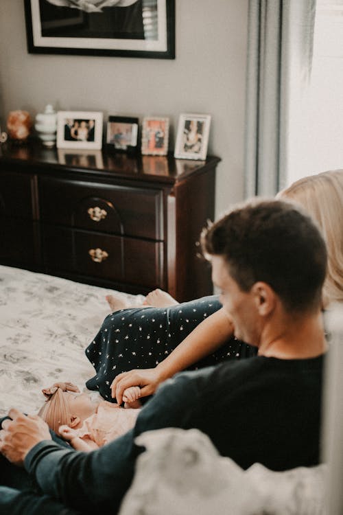 Photo of a Family with a Newborn, Sitting in a Living Room