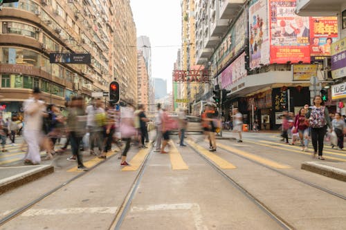 A Blurry Photo of People Crossing the Pedestrian Lane