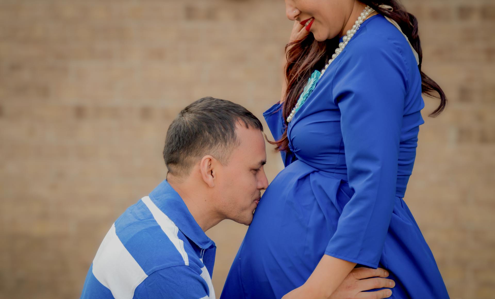 Man Kissing Woman's Belly