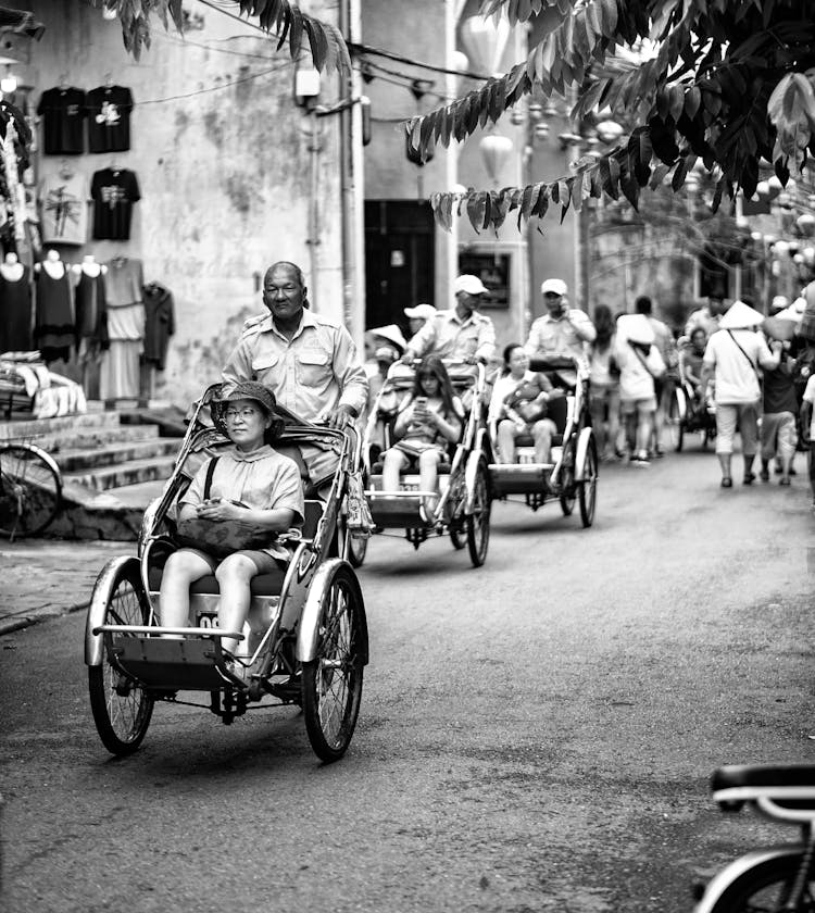 People In Rickshaws On A Street