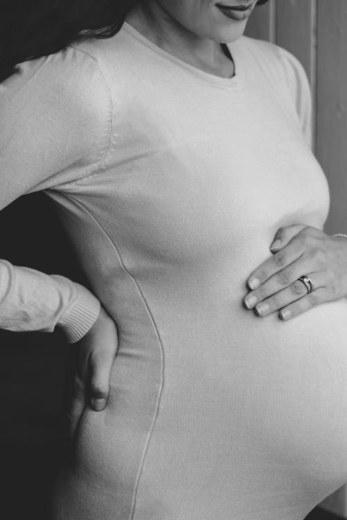 Free A Grayscale Photo of a Pregnant Woman Stock Photo