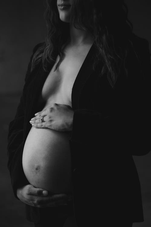 Grayscale Photo of Pregnant Woman in Black Blazer