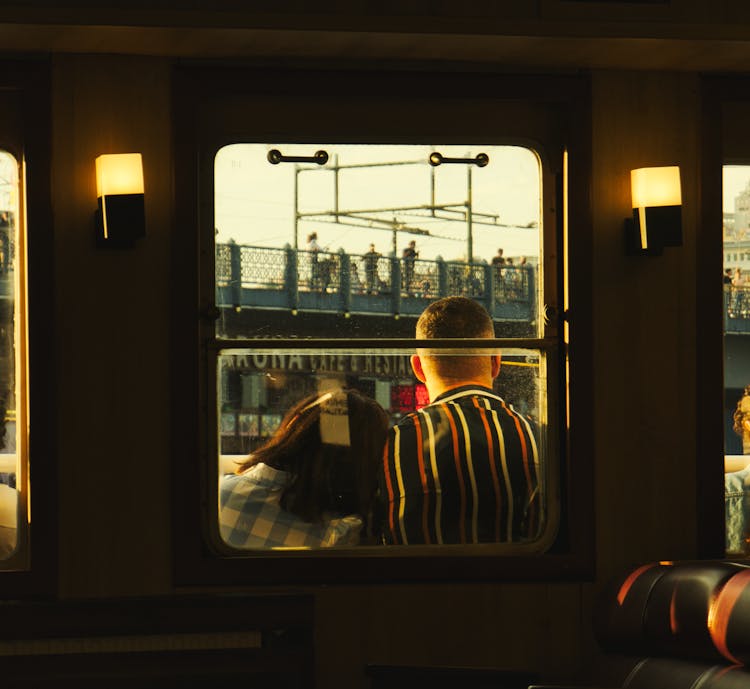 A Couple Behind A Train Window