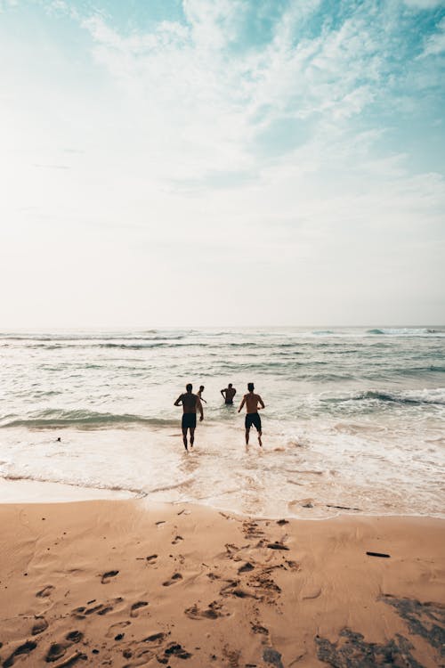 Free People Running Near Seashore at Daytime Photo Stock Photo