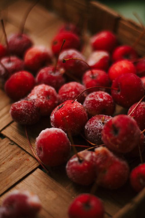 A Red Frozen Cherries on a Woven Mat