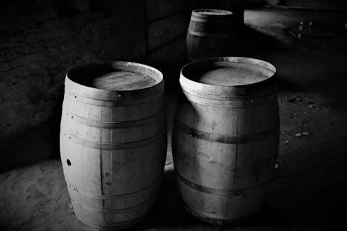 A Grayscale Photo of Wooden Barrels