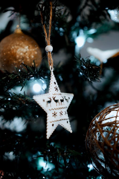 White Star Ornament Hanging on a Christmas Tree  