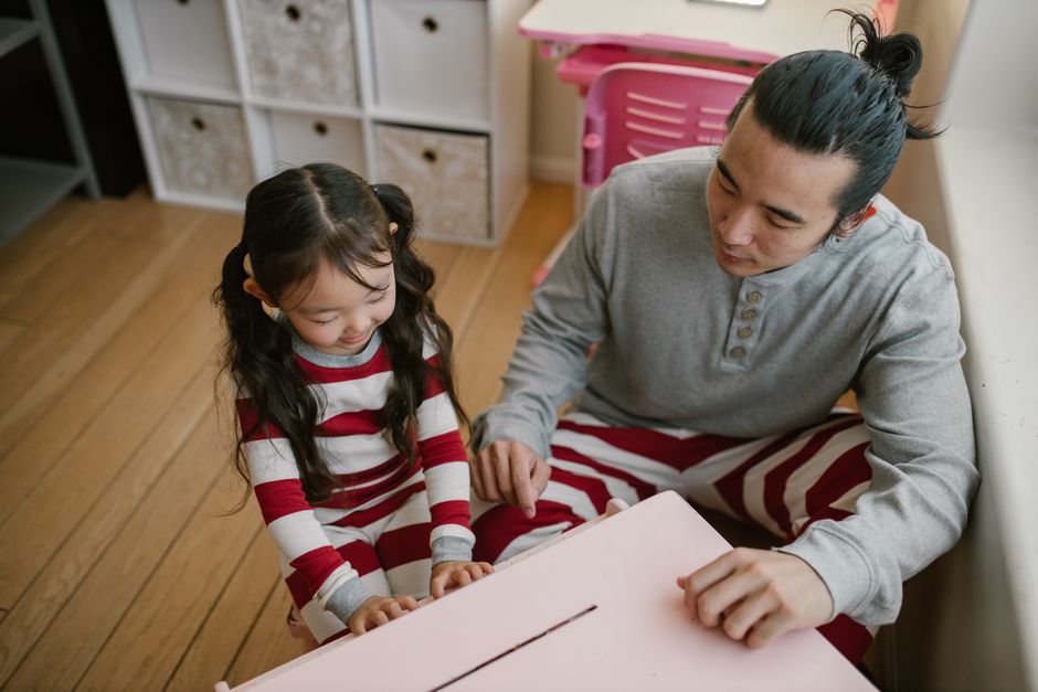 Photo by RDNE Stock project on Pexels Father and daughter bonding while playing a toy piano indoors, capturing a moment of togetherness. - Photo by RDNE Stock project on Pexels