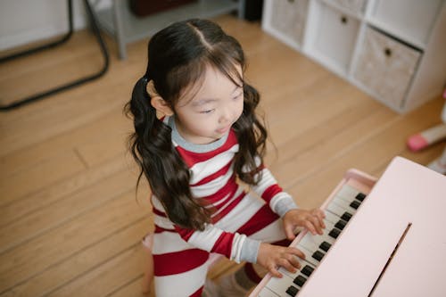 Free Girl Playing Toy Piano Stock Photo