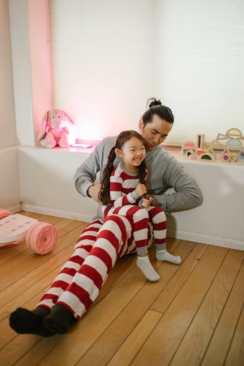 Father Playing with Daughter at Home