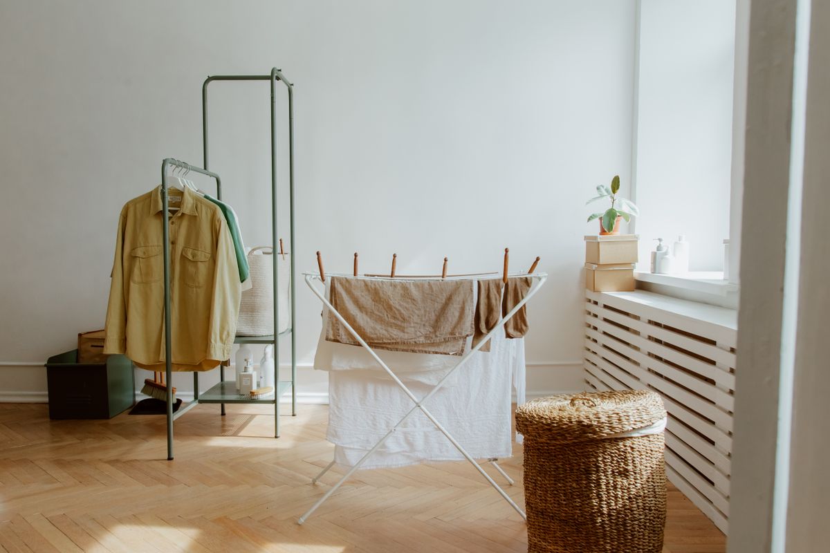 Organized laundry room with drying rack and laundry storage