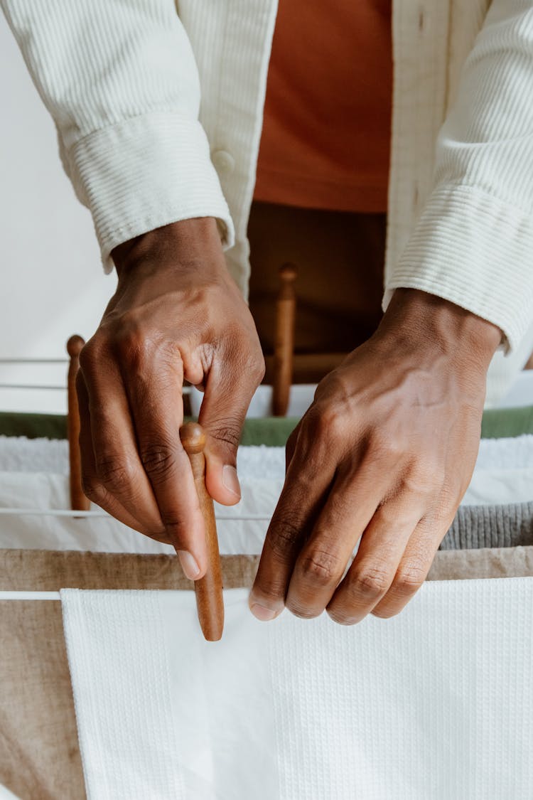 Close Up Of Male Hands Hanging Laundry