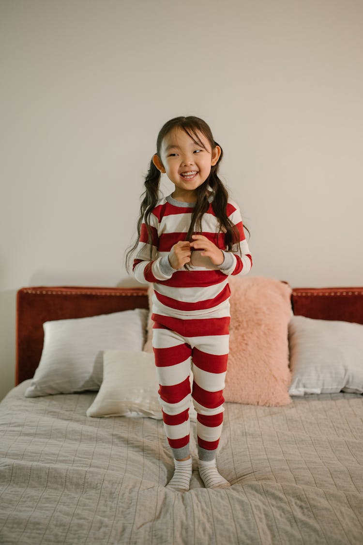 Girl Standing On Bed