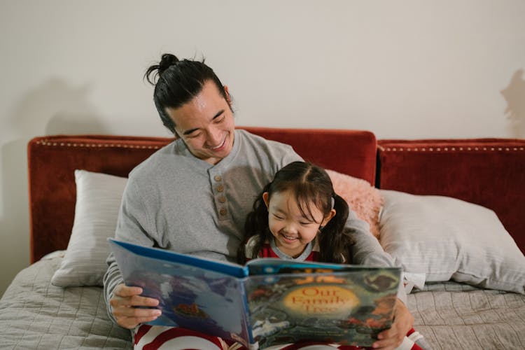 Father Reading Book With His Daughter