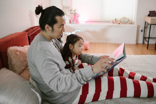 Free Father Reading Book to His Child Stock Photo