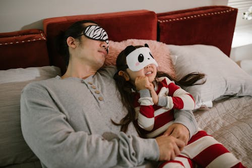 Father and Daughter Lying in Bed