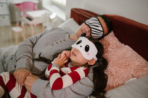 Free Father Putting Daughter to Sleep Stock Photo