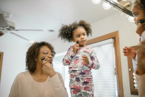 Girl and Woman in front of Mirror