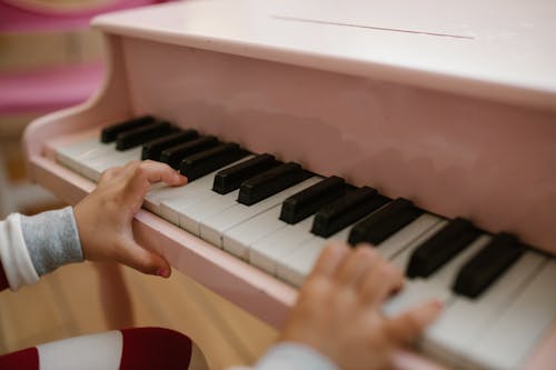 Child Hands on Piano Keys