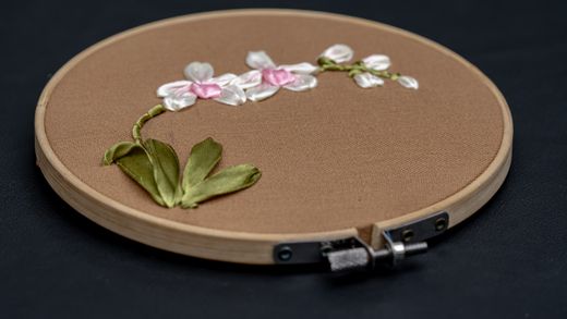 Floral hand embroidery stretched in a wooden hoop — photo by Mohamed Rizly on Pexels
