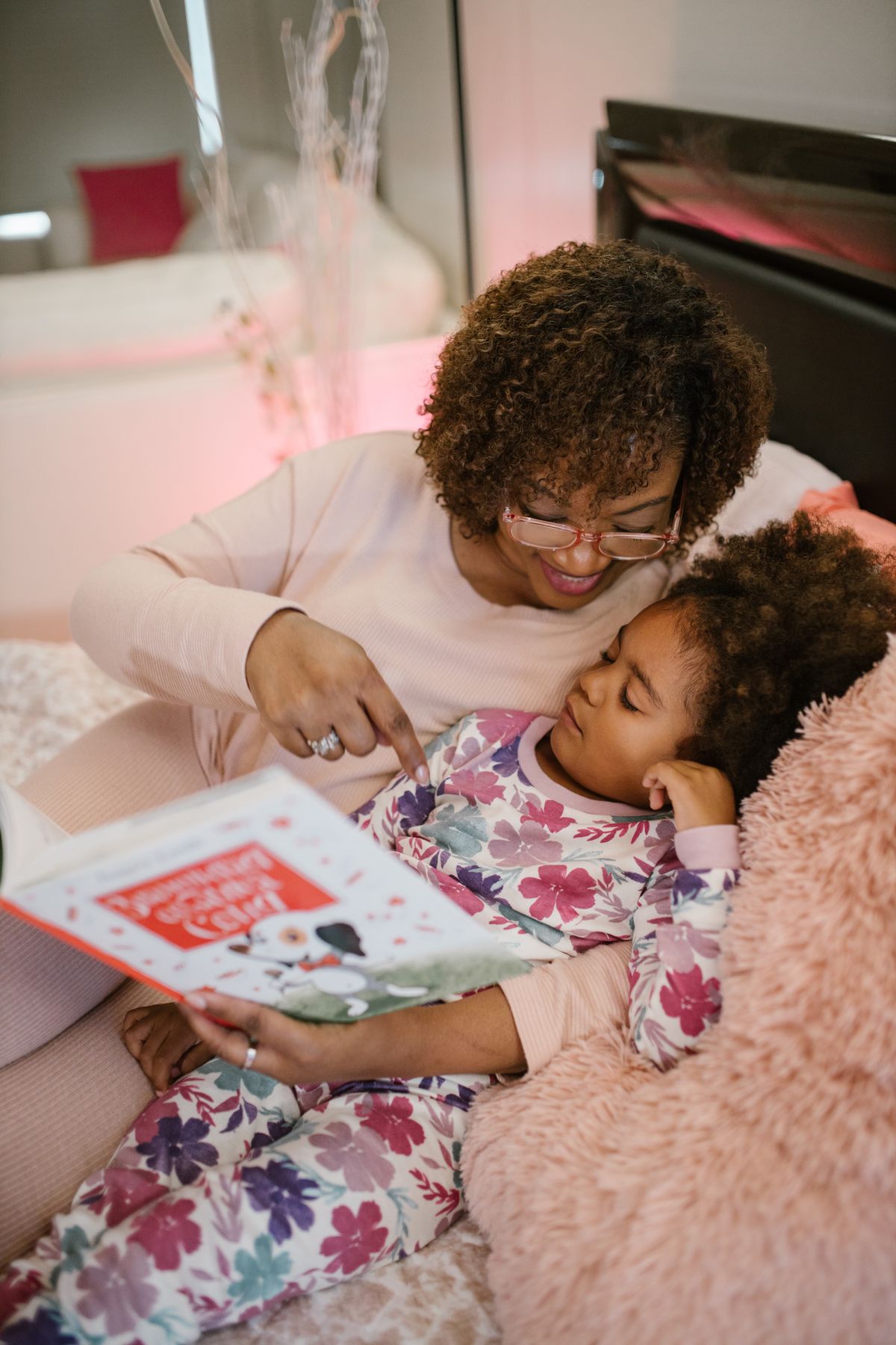 Mother reading a book with her daughter