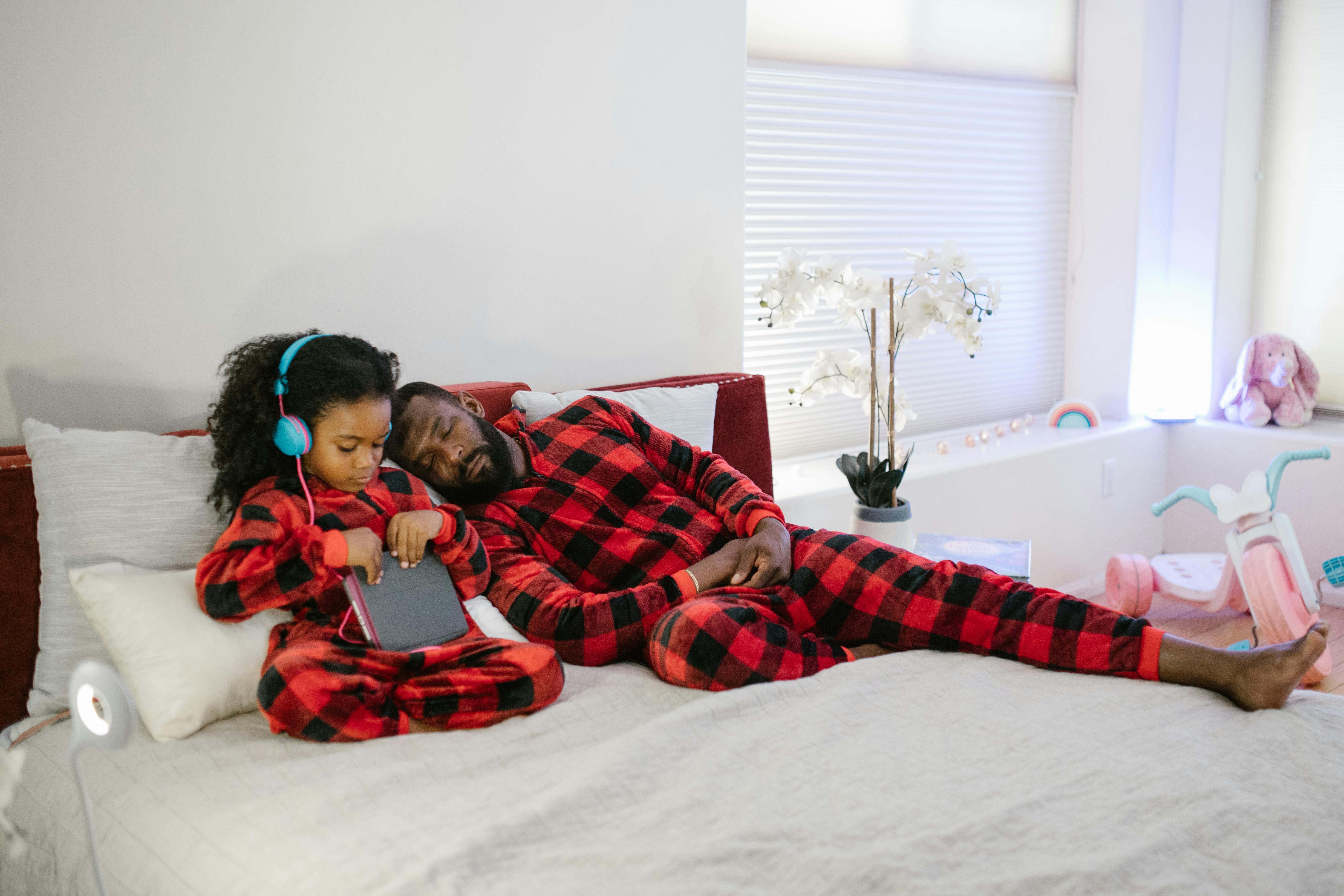 Candid black man and kid on bed · Free Stock Photo