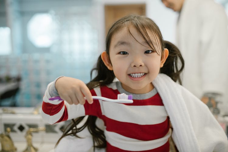 Cheerful Child While Cleaning Teeth