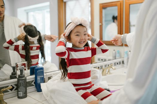 Father and daughter enjoying a cheerful morning routine in their home bathroom.