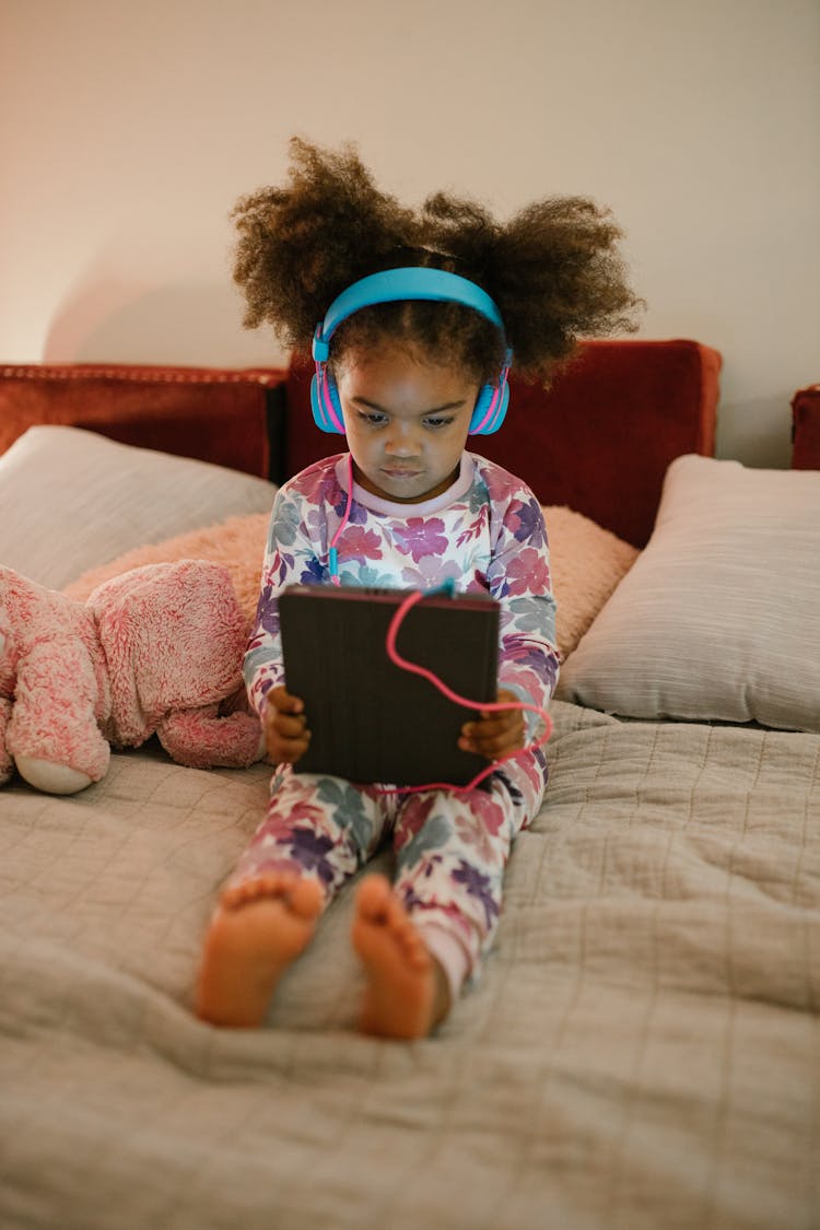 Child Listening To Music From Tablet