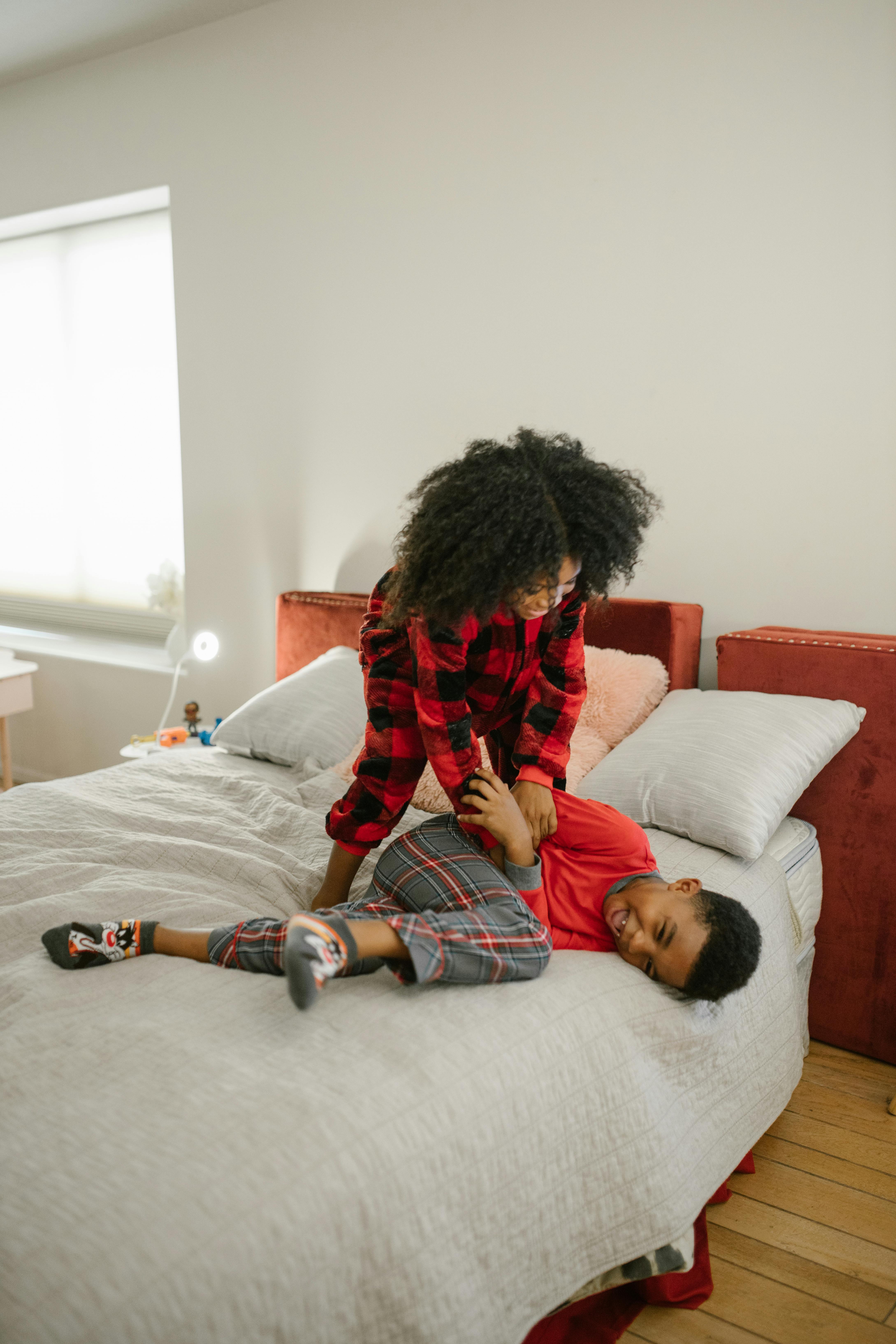 Sister and Brother Playing on Bed · Free Stock Photo