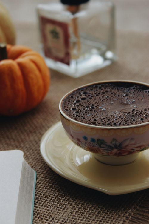 Free A warm cup of hot chocolate on a burlap table with autumn decorations, perfect for cozy fall moments. Stock Photo