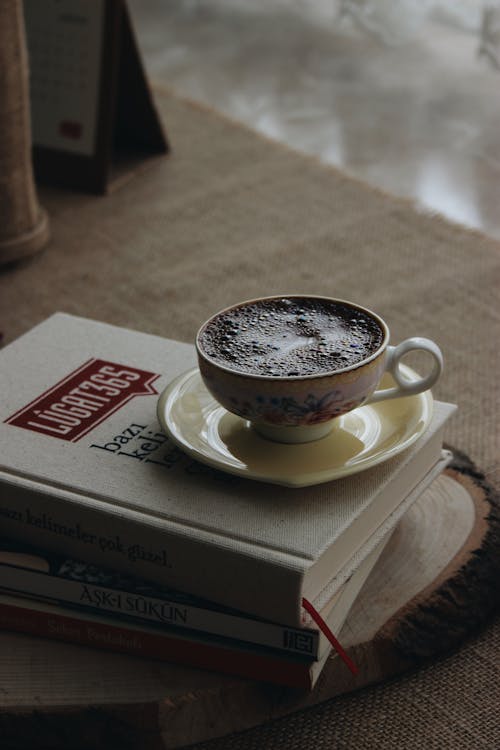 A Cup of Coffee on Top of the Books