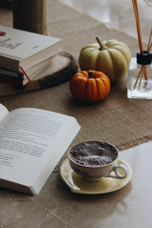 Free Warm autumn setting with coffee, books, pumpkins, and aromatics. Perfect for fall relaxation. Stock Photo