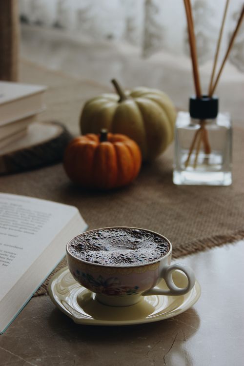 Free A warm autumn scene featuring a coffee cup, pumpkins, and an open book, perfect for cozy reading. Stock Photo