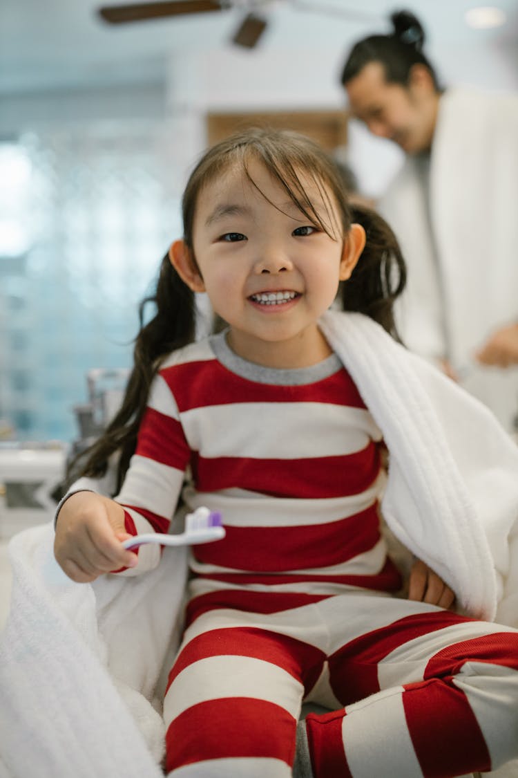 Sitting Girl Holding Toothbrush