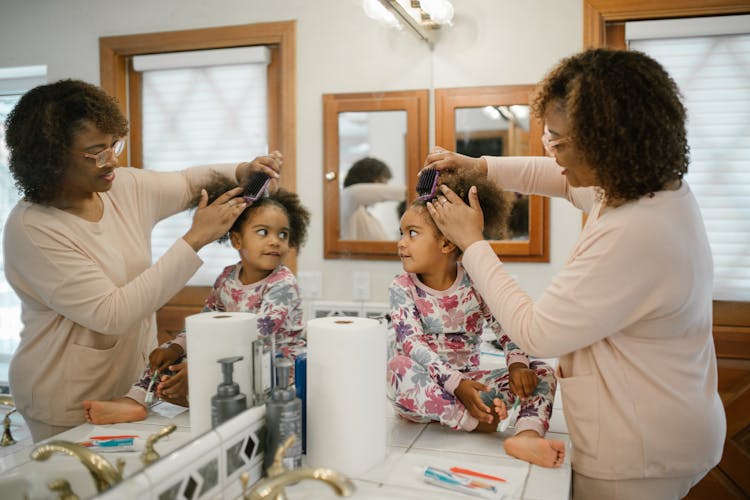 Mother Combing Daughter Hair