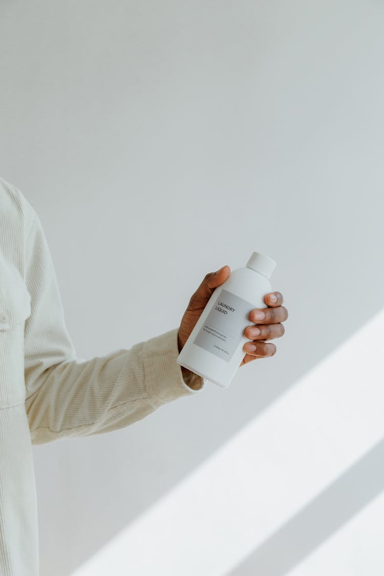 Hand Holding Bottle Of Cleaning Product