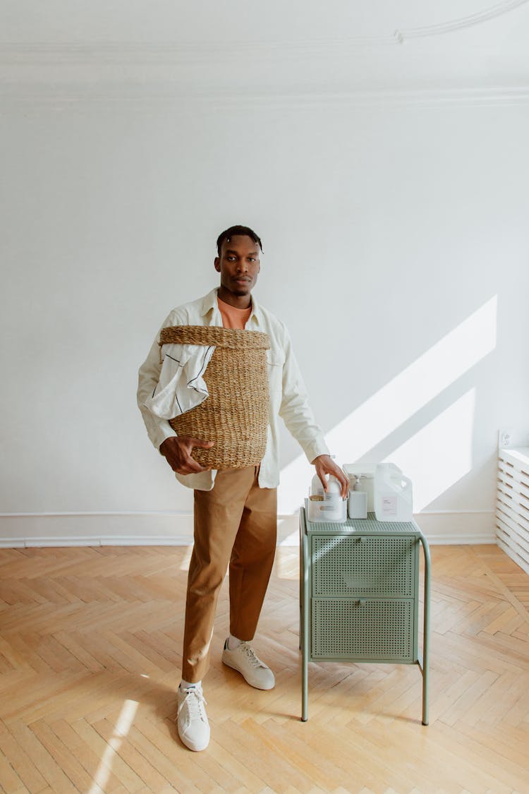 Black Haired Man In Shirt Holding Laundry Basket